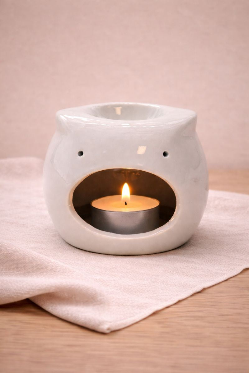 Incalzitor ceramic pentru uleiuri esentiale cu lumanare tip pastila aprinsa